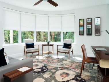 Office area with guest seating and wide window views